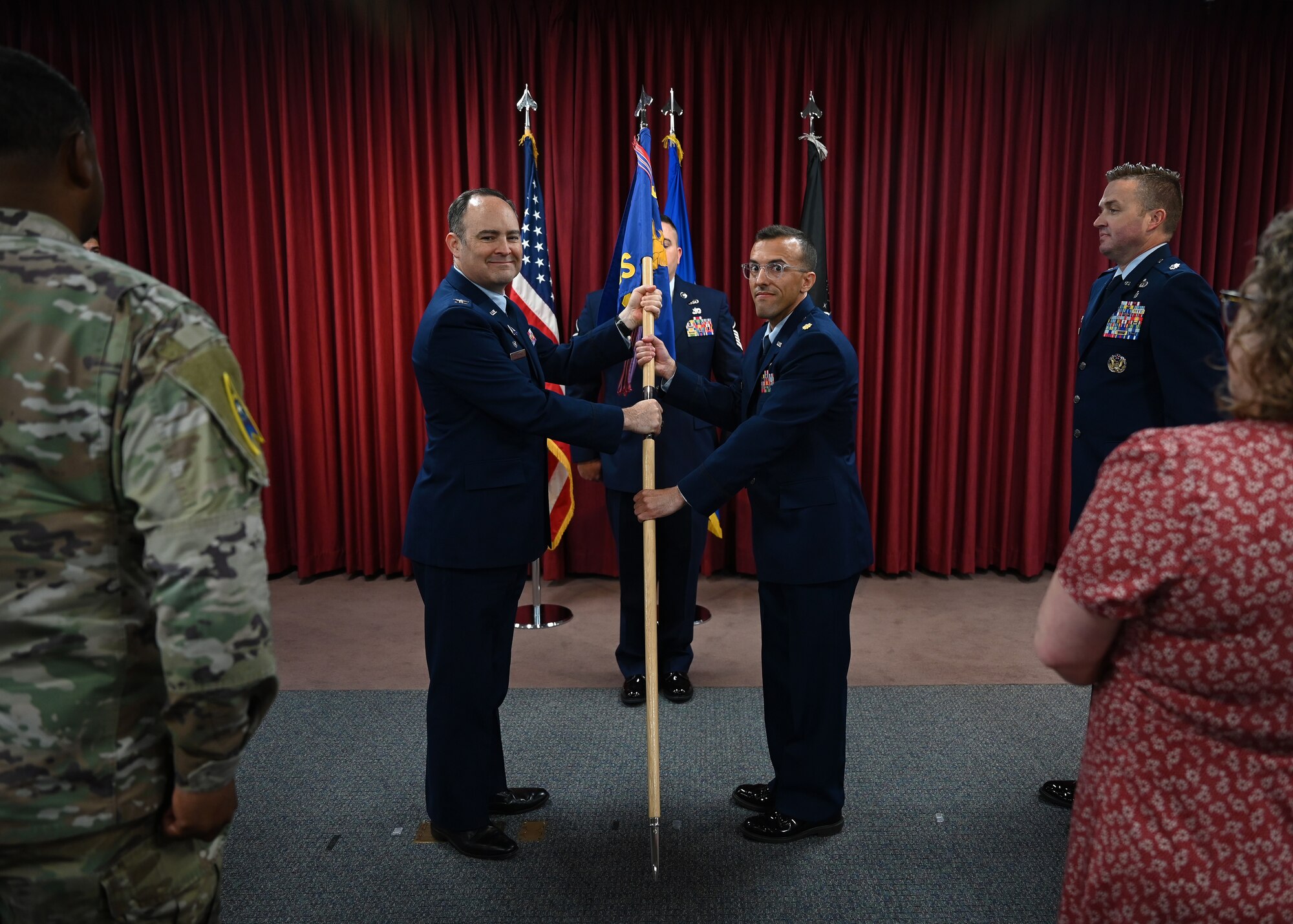 A man passes a flag to another man.