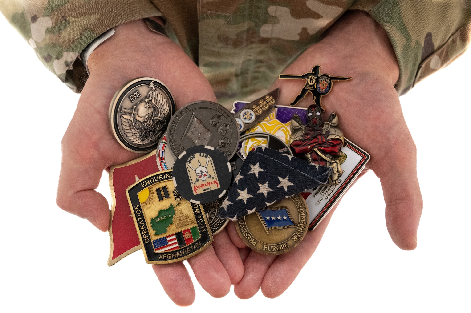 U.S. Air Force Tech. Sgt. Chase Hoyt, 325th Logistics Readiness Squadron noncommissioned officer in charge of inspections, displays challenge coins and a flag he received from past deployments at Tyndall Air Force Base, Florida, June 11, 2024.