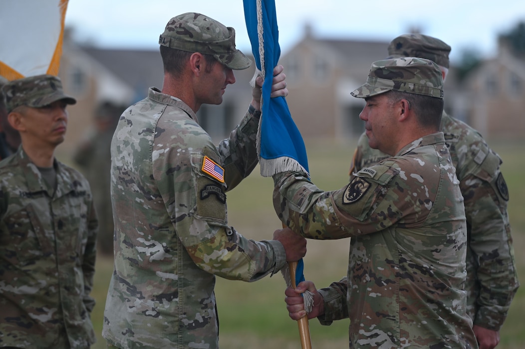 U.S. Army Col. Brenden Dever, 111th Military Intelligence Brigade commander, passes the guidon to Lt. Col Raymond Kuderka, incoming 344th Military Intelligence Battalion commander, at the 344th MI BN change of command ceremony at Fort Concho, San Angelo, Texas, June 18, 2024. Passing of the guidon is a symbolic tradition meant to show the outgoing commander relinquishing his duties to the incoming commander. (U.S. Air Force photo by Airman 1st Class Brian Lummus)