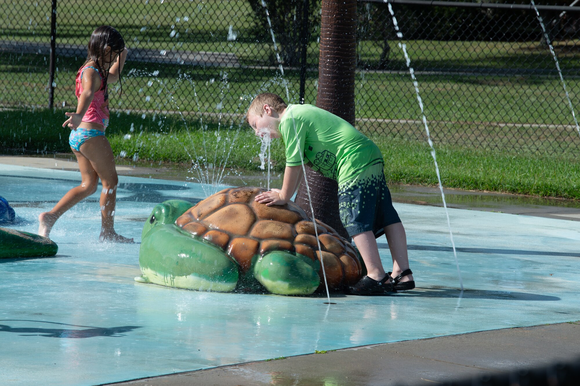 Military children play in the water during a Hearts Apart dinner at Moody Air Force Base, Georgia, June 20, 2024. Most families that attended brought their children along to enjoy the food and games. (U.S. Air Force photo by Airman 1st Class Iain Stanley)