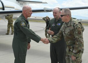 Man shakes another man's hand