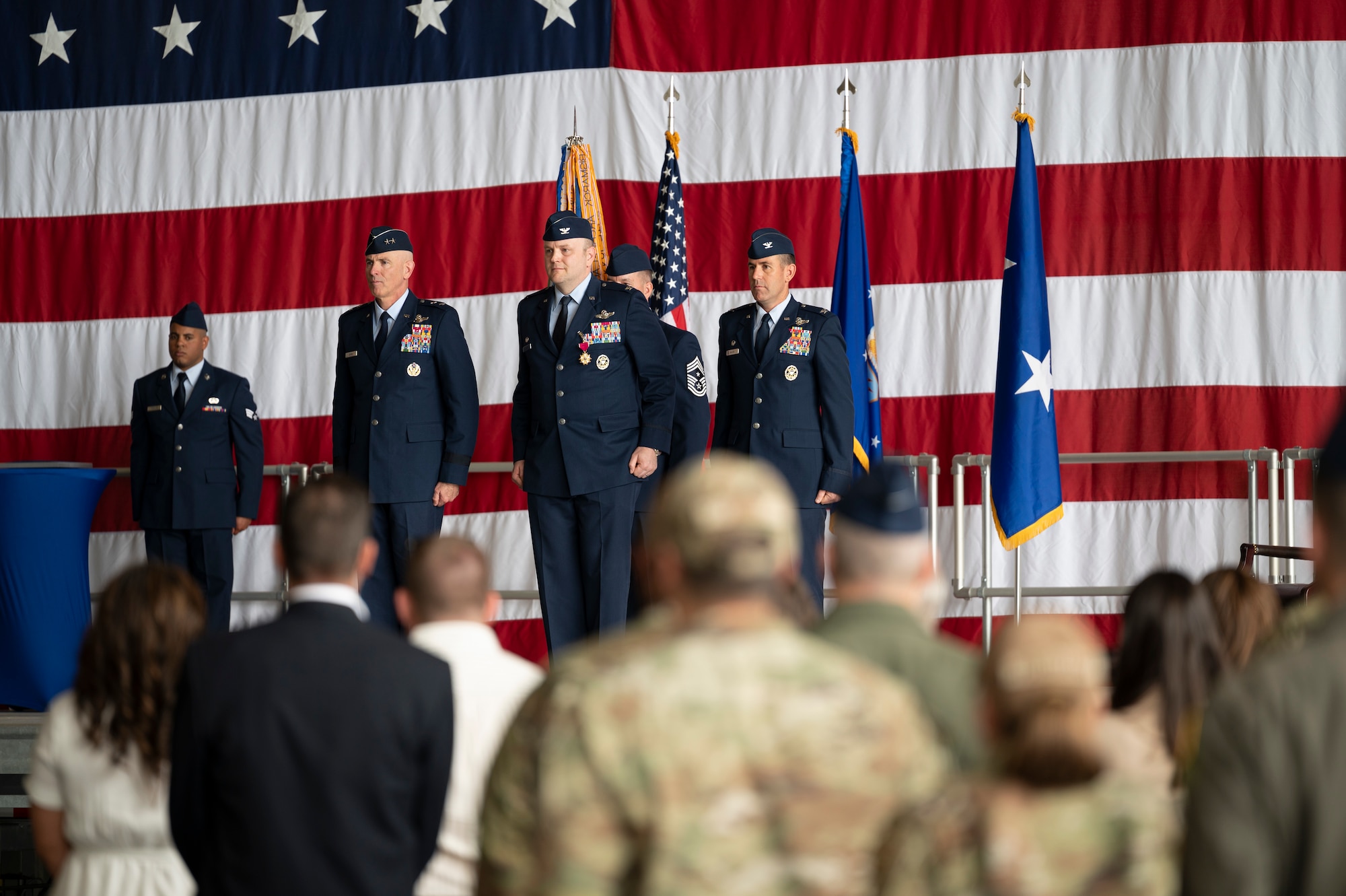 Men stand on stage.