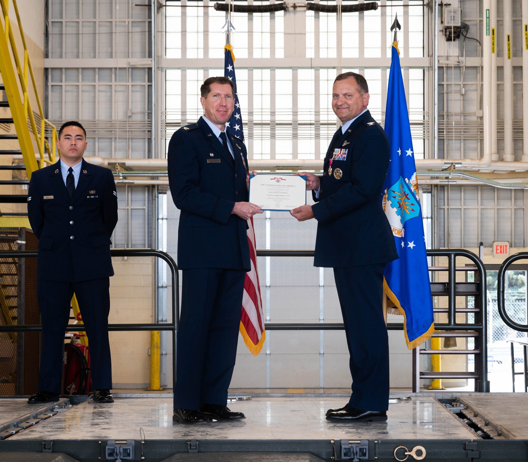 U.S. Air Force Col. Christopher Cain, outgoing 5th Operations Group (5th OG) commander (right), accepts the Legion of Merit medal from Col. Daniel Hoadley, 5th Bomb Wing commander (left), during the 5th OG change of command ceremony at Minot Air Force Base, North Dakota, June 21, 2024. The Legion of Merit is an award that is earned through exceptionally meritorious conduct in the performance of outstanding services and achievements (U.S. Air Force photo by Airman 1st Class Luis Gomez)