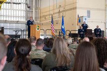 U.S. Air Force Col. John Burrell, incoming 5th Operations Group (5th OG) commander, speaks during the 5th OG Change of Command ceremony at Minot Air Force Base, North Dakota, June 21, 2024. Before taking command of the 5th OG, Burrell was the Nuclear Operations Division Chief, at the Pentagon, Arlington, Virginia. Responsible for standardizing Nuclear Command and Control operations, policy, and Nuclear Surety across the National Military Command System. (U.S. Air Force photo by Airman 1st Class Luis Gomez)