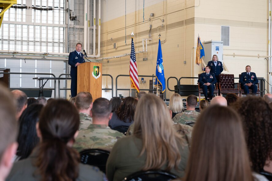 U.S. Air Force Col. John Burrell, incoming 5th Operations Group (5th OG) commander, speaks during the 5th OG Change of Command ceremony at Minot Air Force Base, North Dakota, June 21, 2024. Before taking command of the 5th OG, Burrell was the Nuclear Operations Division Chief, at the Pentagon, Arlington, Virginia. Responsible for standardizing Nuclear Command and Control operations, policy, and Nuclear Surety across the National Military Command System. (U.S. Air Force photo by Airman 1st Class Luis Gomez)