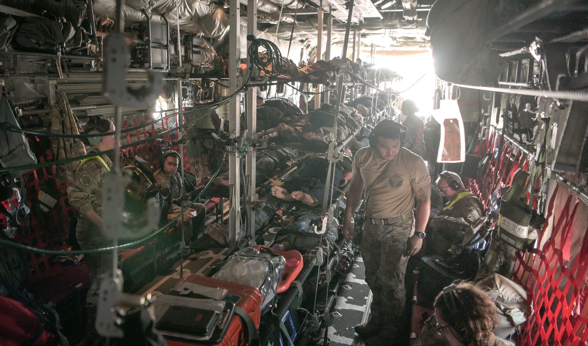 Airmen load simulated patients onto an aircraft
