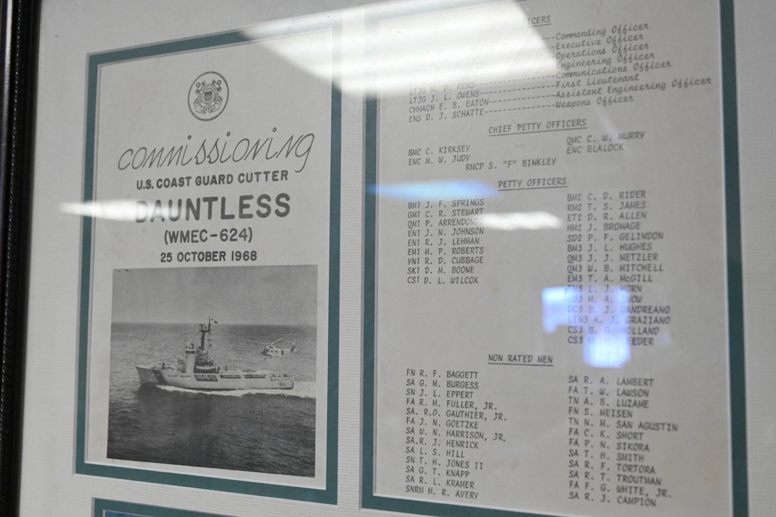 Framed memorabilia from U.S. Coast Guard Cutter Dauntless' (WMEC 624) 1968 commissioning is displayed aboard the cutter, June 21, 2024, while moored in Pensacola, Florida. Dauntless was recognized after 56 years of service to the nation during a heritage recognition ceremony in the presence of current and former crew members, family, and friends before it was placed in commission, special status. (U.S. Coast Guard photo by Petty Officer 2nd Class Brandon Hillard)