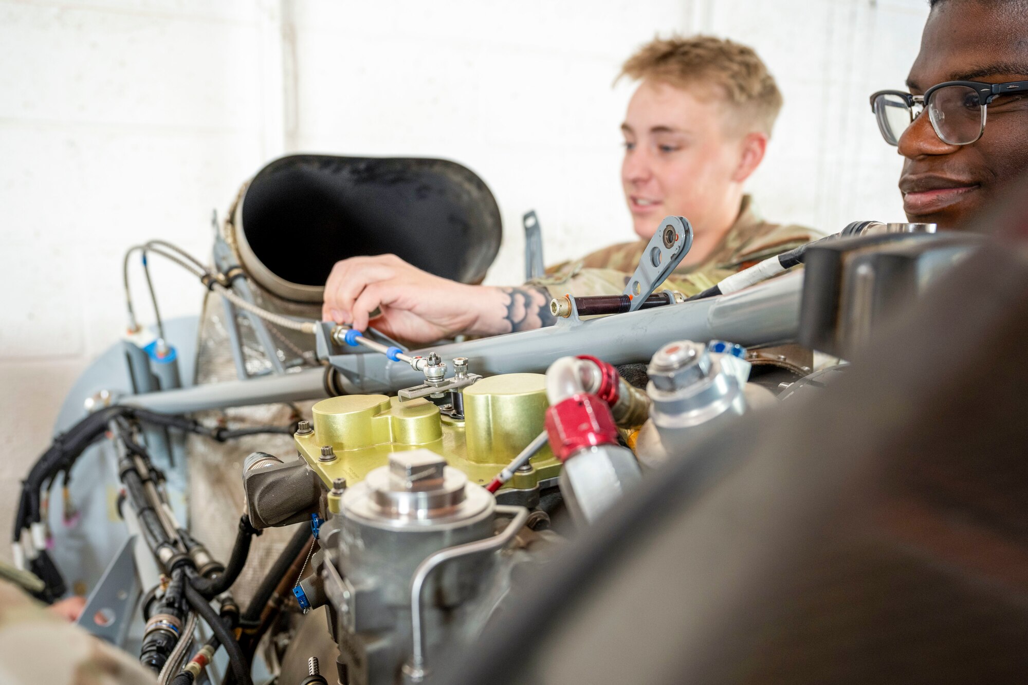 U.S. Air Force Airmen 1st Class Kennedy Richardson, left, and Justin Dacosta, 29th Aircraft Maintenance Unit avionics technicians, inspect turboprop engine lines for leaks at Holloman Air Force Base, New Mexico, June 14, 2024. The Multi-Capable Airmen training program grants Airmen the opportunity to receive full certification, allowing them to specialize in avionics, crew chief and weapons training. (U.S. Air Force photo by Airman 1st Class Michelle Ferrari)