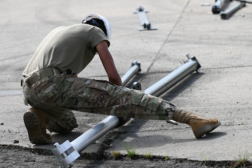 U.S. Air Force Airmen from 1st Munitions Squadron start construction on a munitions assembly conveyor (MAC) in preparation for the Air Force Combat Operation Competition, at Joint Base Langley- Eustis, Virginia, June 3, 2024. The MAC is used to transport munitions systems and explosives. (U.S. Air Force Photo by Airman 1st Class Gerald Ligeralde)