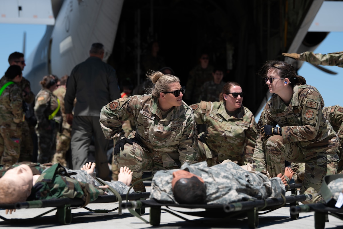 Airmen practice transporting simulated patients off of an aircraft