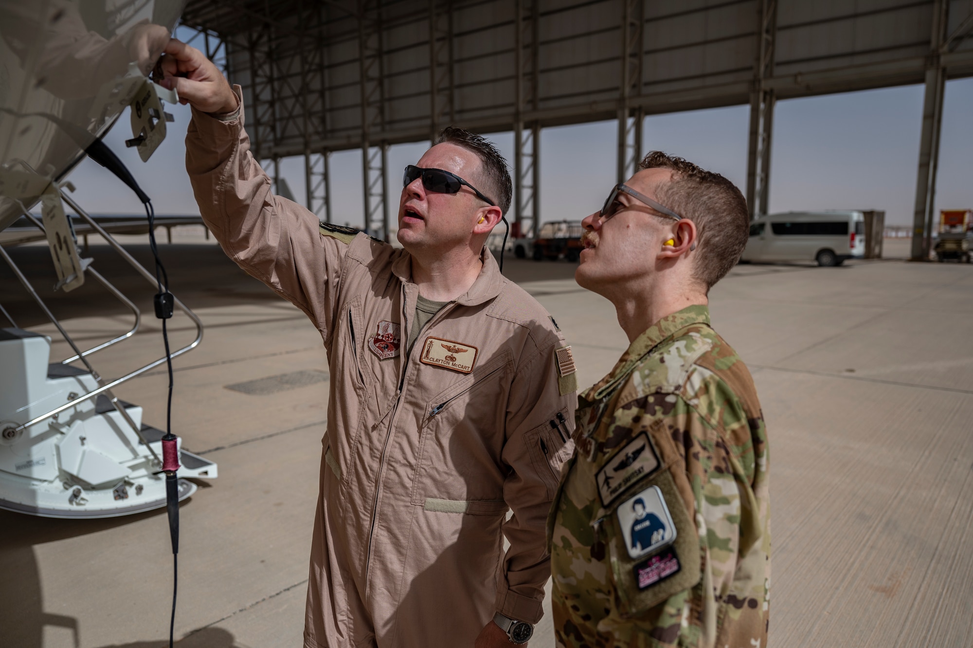Two U.S. Air Force E-11A Aircraft pilots assigned to the 430th Expeditionary Electronic Combat Squadron perform a preflight inspection at an undisclosed location within the U.S. Central Command area of responsibility, May 7, 2024. 
The E-11 provides a crucial common operating picture that enables all air assets involved in airdrops to deliver aid precisely and on time. (U.S. Air Force photo)