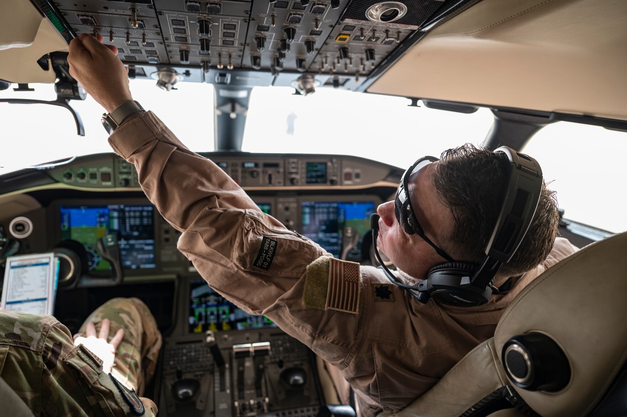 A U.S. Air Force E-11A Aircraft pilot assigned to the 430th Expeditionary Electronic Combat Squadron performs a preflight check at an undisclosed location within the U.S. Central Command area of responsibility, May 7, 2024. When satellite phones are ineffective due to line-of-sight constraints, the E-11 steps in as a data translator. It bridges communication gaps between different airframes, allowing effective collaboration among U.S. and UK airlift assets during airdrop missions. (U.S. Air Force photo)