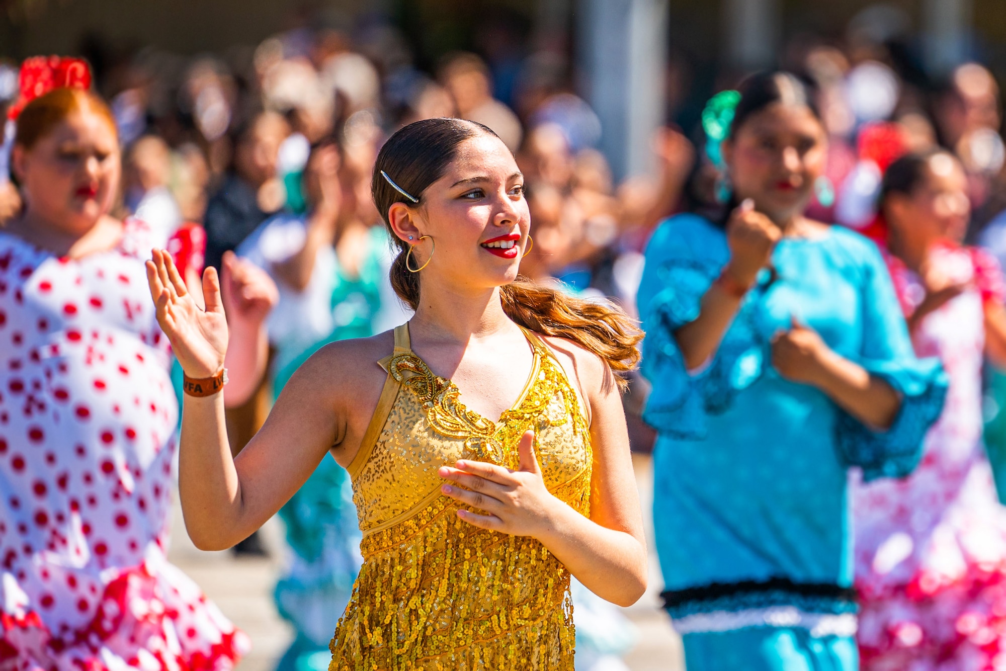 Colorfully dressed dancers entertain attendees of a parade during the Lompoc Flower Festival Parade in Lompoc.