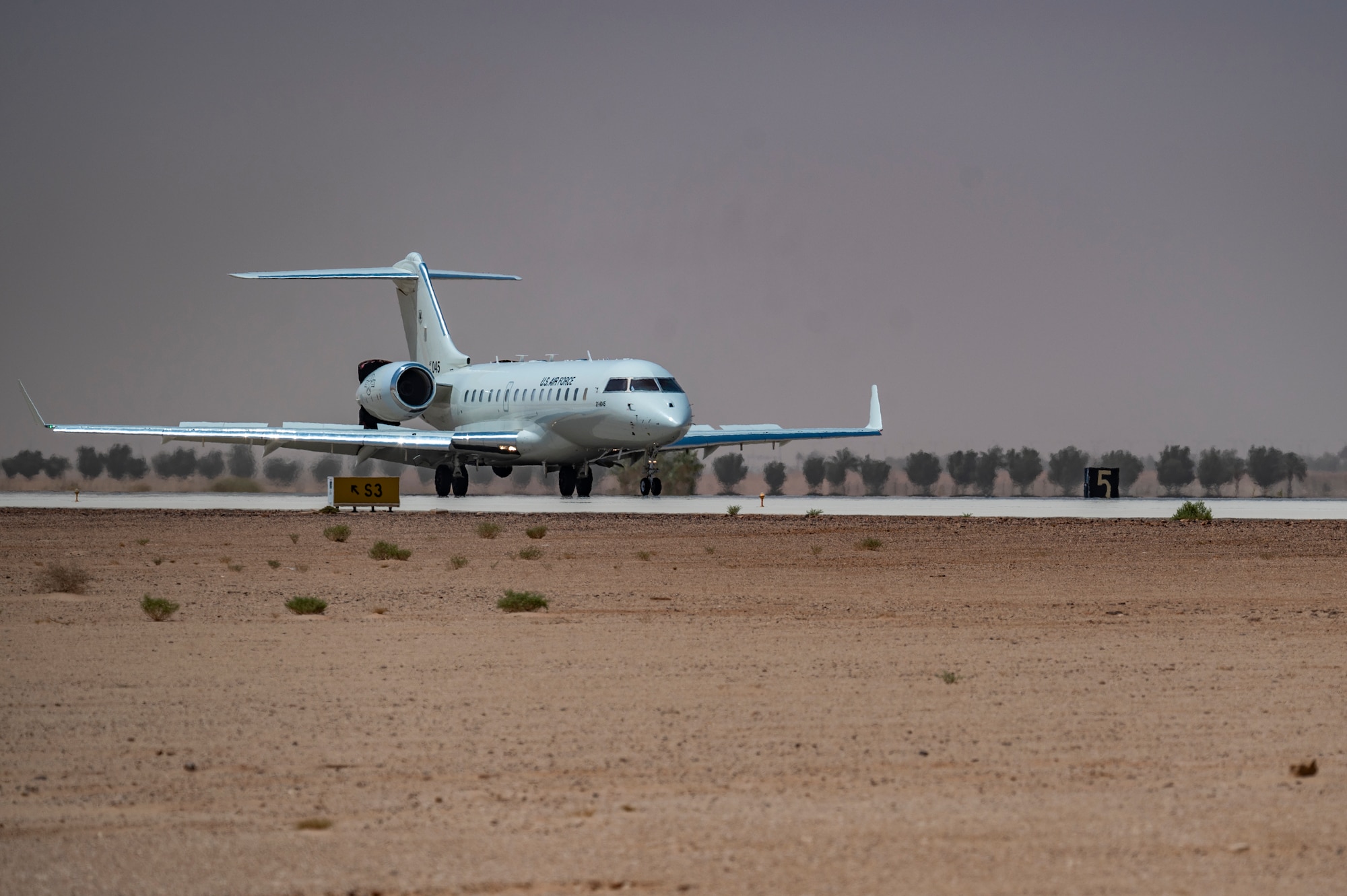 A U.S. Air Force E-11A Aircraft equipped with the Battlefield Airborne Communications Node lands on the flightline at an undisclosed location within the U.S. Central Command area of responsibility, May 9, 2024. The E-11 provides a crucial common operating picture that enables all air assets involved in any airdrop mission to deliver aid precisely and on time. (U.S. Air Force photo)