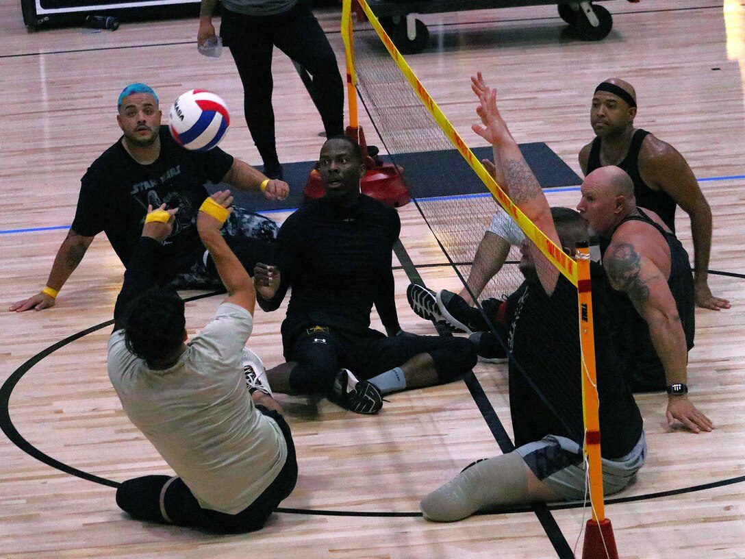 Team Army is taking advantage of some practice time during a sitting volleyball workout during the 2024 Department of Defense Warrior Games at the ESPN Wide World of Sports Complex in Orlando, Florida