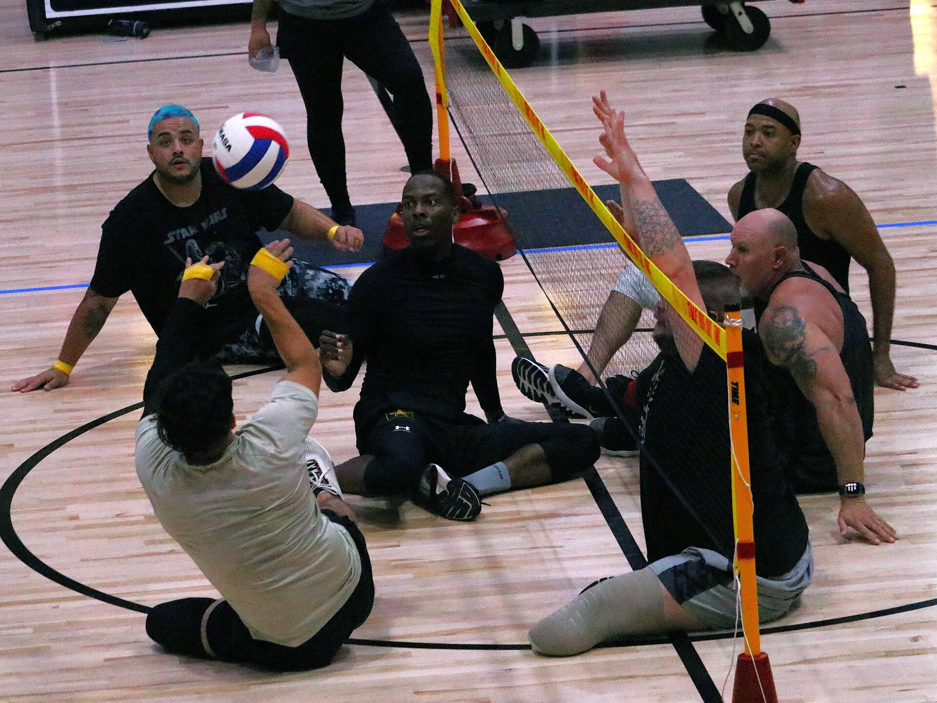 Team Army is taking advantage of some practice time during a sitting volleyball workout during the 2024 Department of Defense Warrior Games at the ESPN Wide World of Sports Complex in Orlando, Florida