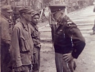 Pvt. Lawrence Spier (left) speaks with Gen. Dwight D. Eisenhower.