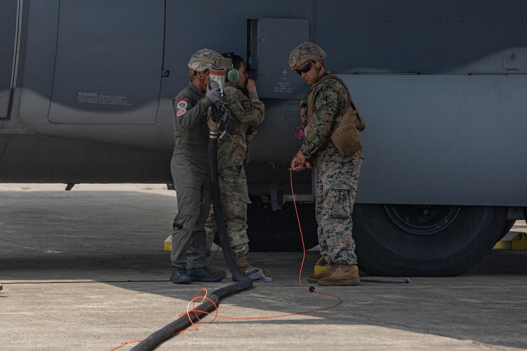 U.S. Marines with Marine Wing Support Squadron (MWSS) 371, Marine Air Control Group 38, 3rd Marine Aircraft Wing, and Philippine Sailors disconnect a fuel line from a U.S. Air Force MC-130J Commando II assigned to 1st Special Operations Squadron during forward arming and refueling point operations at Laoag International Airport, Laoag, Philippines, June 15, 2024. The FARP supported aircraft with Marine Aerial Refueler Transport (VMGR) 352, Marine Aircraft Group 11, 3rd MAW, and 1st Special Operations Squadron during Marine Aviation Support Activity 24. MASA is an annual Philippine-U.S. military exercise focused on mutual defense, strengthening relationships, and rehearsing emerging aviation concepts. (U.S. Marine Corps photo by Cpl. Nikolas Mascroft)