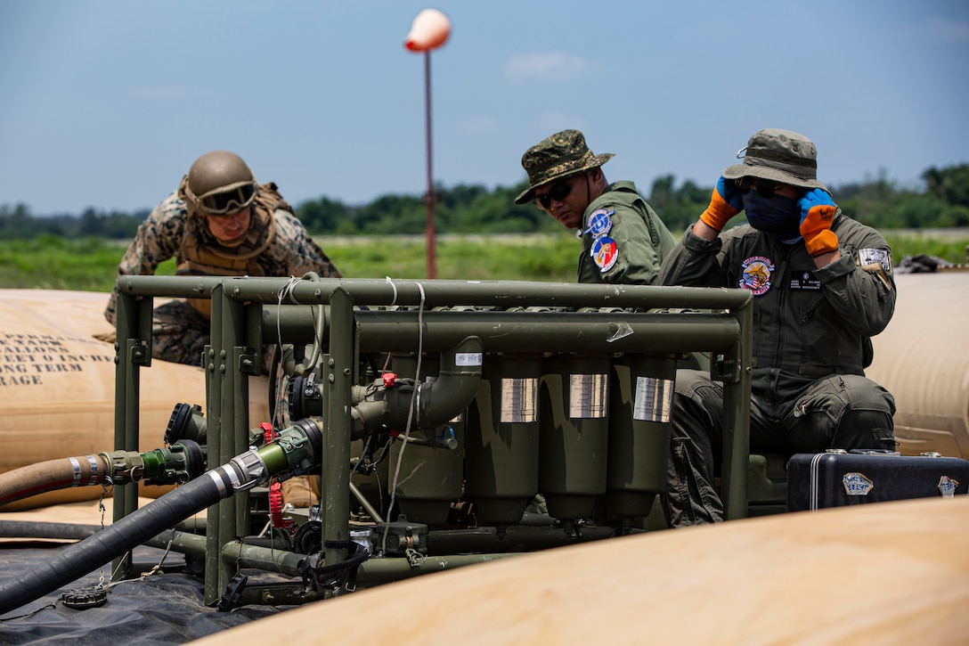 U.S. Marines with Marine Wing Support Squadron (MWSS) 371, Marine Air Control Group 38, 3rd Marine Aircraft Wing, and Philippine Sailors refuel a U.S. Air Force MC-130J Commando II assigned to 1st Special Operations Squadron during forward arming and refueling point operations at Laoag International Airport, Laoag, Philippines, June 15, 2024. The FARP supported aircraft with Marine Aerial Refueler Transport (VMGR) 352, Marine Aircraft Group 11, 3rd MAW, and 1st Special Operations Squadron during Marine Aviation Support Activity 24. MASA is an annual Philippine-U.S. military exercise focused on mutual defense, strengthening relationships, and rehearsing emerging aviation concepts. (U.S. Marine Corps photo by Cpl. Nikolas Mascroft)