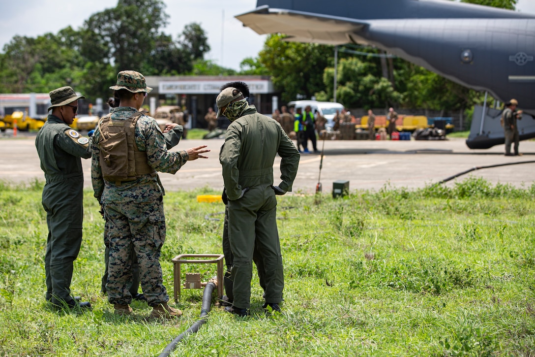 U.S. Marines with Marine Wing Support Squadron (MWSS) 371, Marine Air Control Group 38, 3rd Marine Aircraft Wing, and Philippine Sailors refuel a U.S. Air Force MC-130J Commando II assigned to 1st Special Operations Squadron during forward arming and refueling point operations at Laoag International Airport, Laoag, Philippines, June 15, 2024. The FARP supported aircraft with Marine Aerial Refueler Transport (VMGR) 352, Marine Aircraft Group 11, 3rd MAW, and 1st Special Operations Squadron during Marine Aviation Support Activity 24. MASA is an annual Philippine-U.S. military exercise focused on mutual defense, strengthening relationships, and rehearsing emerging aviation concepts. (U.S. Marine Corps photo by Cpl. Nikolas Mascroft)