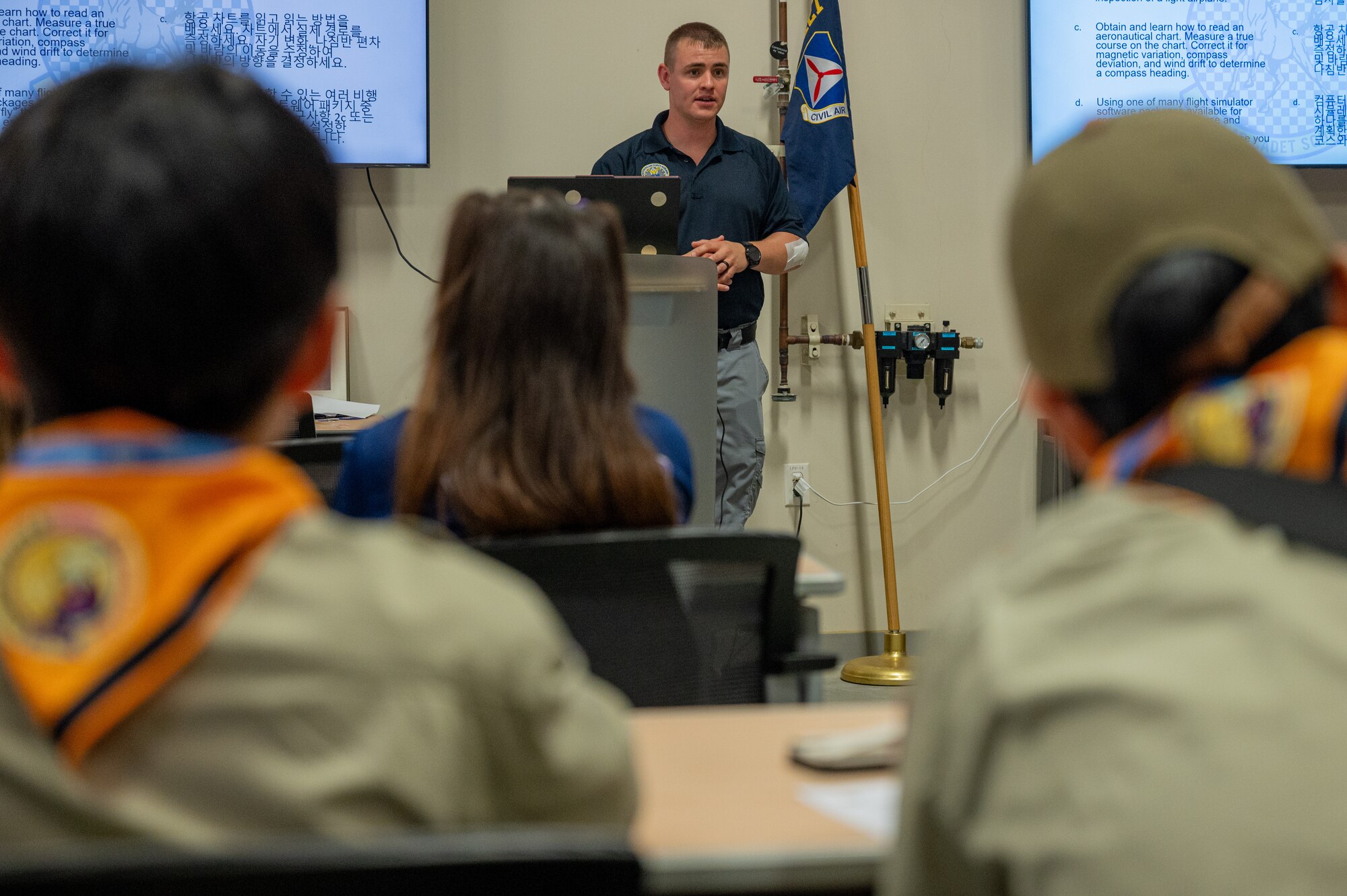 U.S. Air Force Major Kevin Abington, Special Operations Command Korea J-65 plans division chief and Civil Air Patrol Squadron NHQ-127 commander, welcomes participants during a youth aviation day at Osan Air Base, Republic of Korea, June 15, 2024. This event worked to continue the bond and trust of U.S. and ROK citizens by allowing Osan AB service members to engage participants in activities revolving around aviation. (U.S. Air Force photo by Airman 1st Class Chase Verzaal)