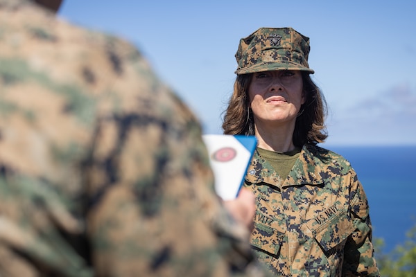 U.S. Navy Cmdr. Julia Savitz is awarded the Fleet Marine Force pin at the top of Mt. Suribachi, Iwo To, Japan, May 24, 2024. The FMF pin signifies an achieved level of excellence and proficiency in Marine Corps operations and indicates a fundamental understanding of the Marine Air-Ground Task Force and its components. Savitz, a native of Washington, is a medical officer with 12th Marine Littoral Regiment, 3d Marine Division.  (U.S. Marine Corps photo by Lance Cpl. Evelyn Doherty)