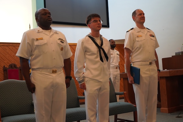 Yorktown, Va. (June 20, 2024) HA Tanner Steward is presented with the Navy and Marine Corps Achievement Medal as the Navy honor graduate of the Tri-Service Optician School’s (TOPS) class 24-005 commencement ceremony by Commander Christopher DeAngelis, Director of the Tri-Service Optician School. The commencement ceremony was held at Nelson Chapel onboard Naval Weapons Station (NWS) Yorktown. The mission of TOPS is to provide formal optical training to Army Optical Laboratory Specialist MOS (68H) and Navy Hospital Corpsman (NEC L19A) students with quality training through a 24-week, DoD, uniformed services school on the subjects of ophthalmic dispensing, ophthalmic fabrication and clinical optics. Upon completing the required curriculum, graduates are immediately able to function as an independent optician in any military environment. (U.S. Navy Photo by Max Lonzanida/Released)