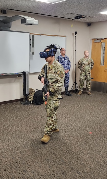 LACKLAND AIR FORCE BASE, Texas – Staff Sgt. Edgar Bravo, a LEAP Scholar Inter-American Air Forces Academy Instructor, shows a Mexican delegation the use of a virtual reality simulator. This allows users to simulate being at a specific air base of their selection and practice all the techniques to defend and protect their resources.