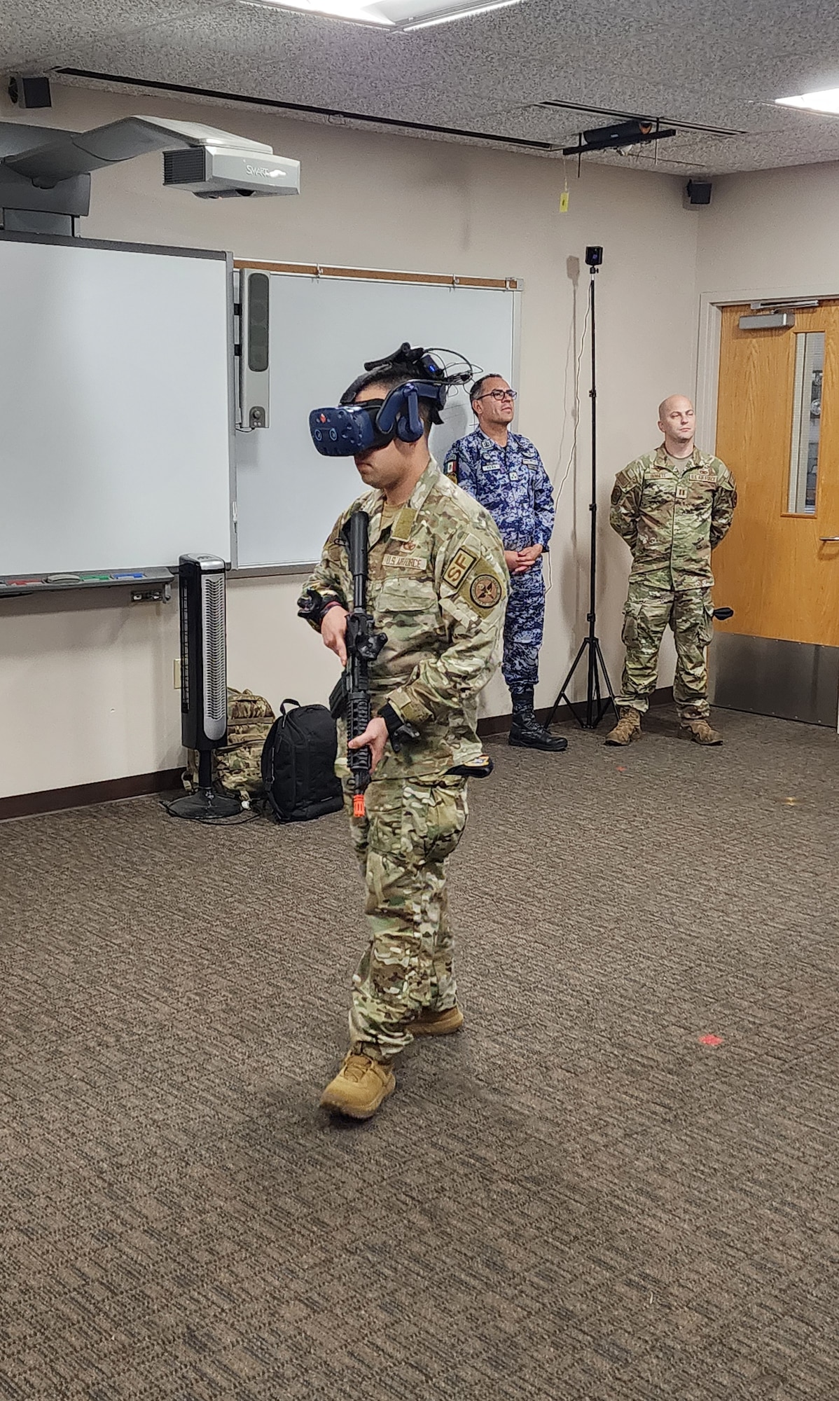 LACKLAND AIR FORCE BASE, Texas – Staff Sgt. Edgar Bravo, a LEAP Scholar Inter-American Air Forces Academy Instructor, shows a Mexican delegation the use of a virtual reality simulator. This allows users to simulate being at a specific air base of their selection and practice all the techniques to defend and protect their resources.