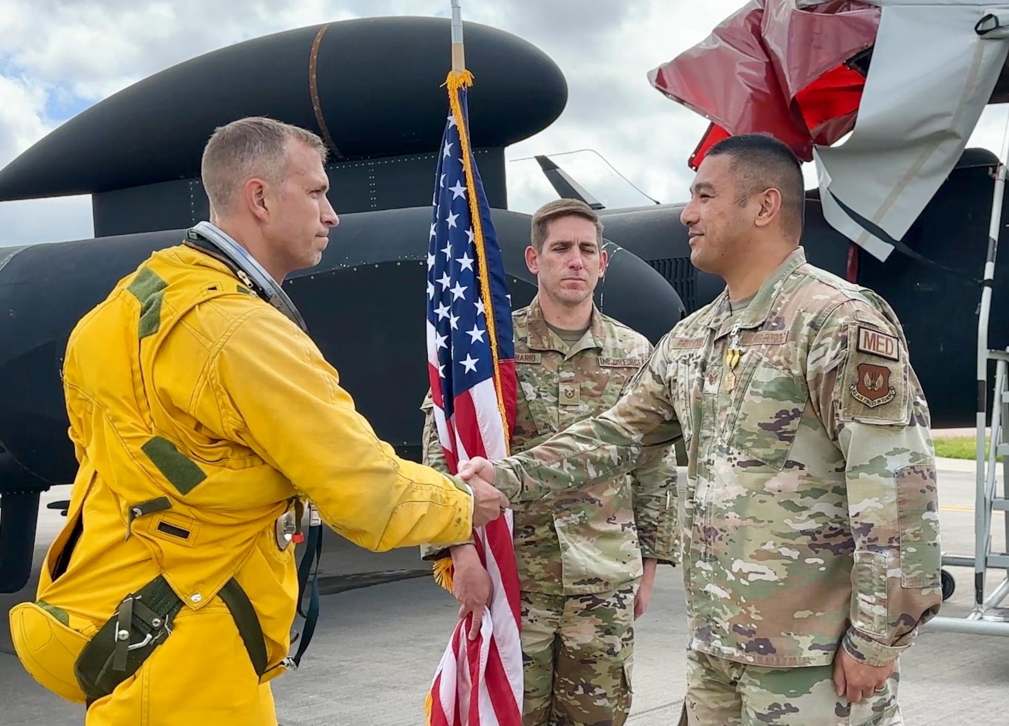 Airmen shake hands during a reenlistment ceremony