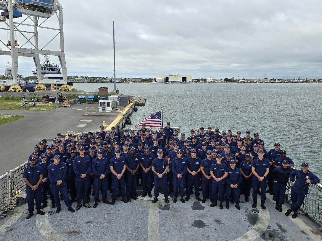 Crew members who were assigned to U.S. Coast Guard Cutter Alert (WMEC 630) when in was homeported in Astoria Oregon pose for a group photo with the new crew of the cutter, June 13, 2024, in Cape Canaveral, Florida. Alert changed home ports as part of the Coast Guard's AY24 Force Alignment Initiative. (U.S. Coast Guard photo)