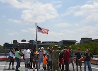 A sailor from the Littoral Combat Ship Squadron (COMLCSRON) 2, gives a tour to visitors on board the littoral combat ship USS Marinette (LCS 25), during Maryland Fleet Week and Flyover Baltimore, 18 June.