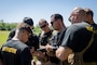 Instructors with Expeditionary Operations Training Group (EOTG), II Marine Expeditionary Force discuss training objectives prior to an execution of a raid carried out by Battalion Landing Team 1/8, 24th Marine Expeditionary Unit, as part of Composite Training Unit Exercise (COMPTUEX) at Trenton, North Carolina, April 24, 2024. The Purpose of COMPTUEX is to train and certify the 24th MEU’s Command Element (CE), Aviation Combat Element (ACE), and Ground Combat Element (GCE) and the Logistics Combat Element (LCE) as a capable Marine Air Ground Task Force (MAGTF) that can execute special skills operations along with the Amphibious Ready Group (ARG). COMPTUEX offers an enhanced opportunity for Navy and Marine Corps interoperability training in preparation for the Wasp ARG-MEU’s upcoming deployment. (U.S. Marine Corps Photo by Sgt. Nathan Mitchell)