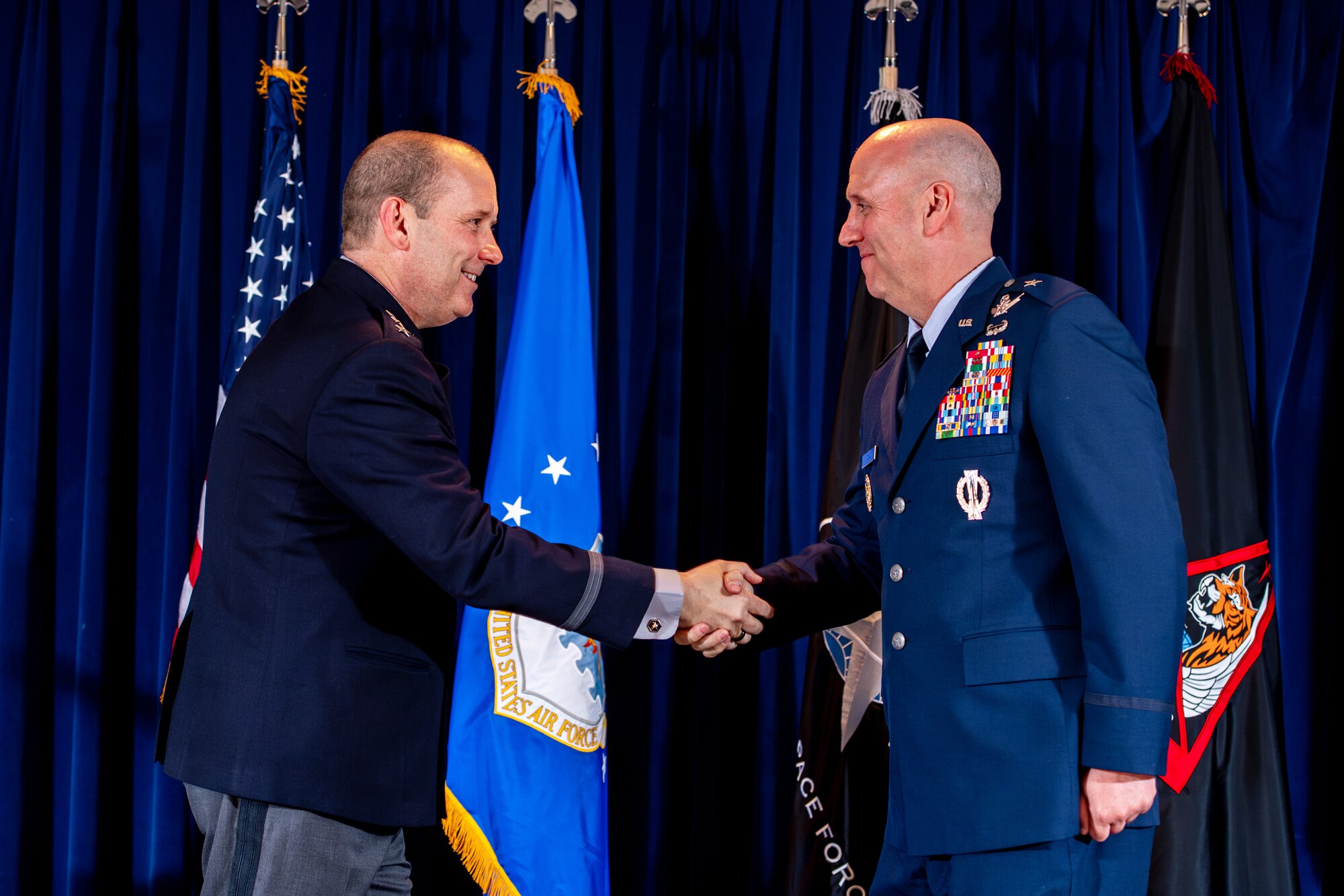 Two men in military uniforms shaking hands