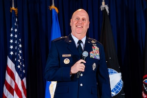 Man in uniform holds microphone