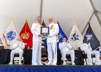 IMAGE: Strategic Systems Programs Director Vice Adm. Johnny Wolfe Jr. (center left) and Capt. Philip Mlynarski display a letter of congratulations from the Chicago Cubs Major League Baseball Organization in honor of Mlynarski’s retirement following a change of command ceremony at Naval Surface Warfare Center Dahlgren Division June 21. Mlynarski who served as NSWCDD’s 47th commanding officer in the final two years of his 26-year career is a lifelong Cubs fan.