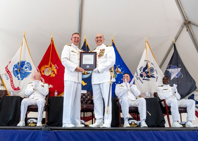 IMAGE: Strategic Systems Programs Director Vice Adm. Johnny Wolfe Jr. (center left) and Capt. Philip Mlynarski display a letter of congratulations from the Chicago Cubs Major League Baseball Organization in honor of Mlynarski’s retirement following a change of command ceremony at Naval Surface Warfare Center Dahlgren Division June 21. Mlynarski who served as NSWCDD’s 47th commanding officer in the final two years of his 26-year career is a lifelong Cubs fan.