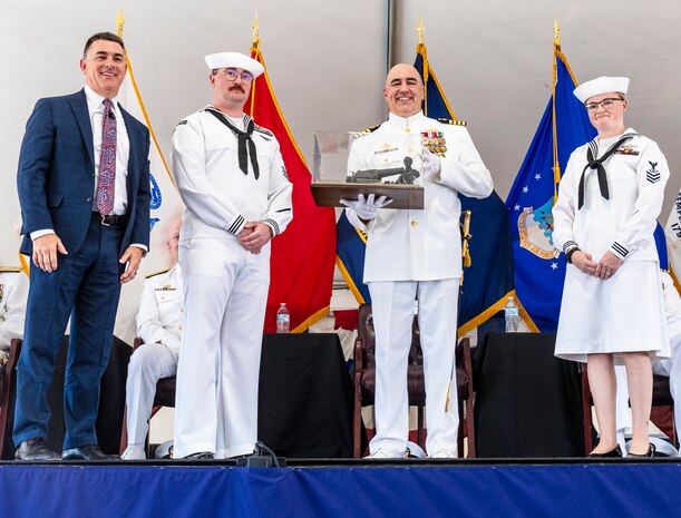 IMAGE: Naval Surface Warfare Center Dahlgren Division Technical Director Dale Sisson Jr., P.E., SES, (left) presented Capt. Philip Mlynarski with a replica of the 11-inch Dahlgren Gun during Mlynarski’s retirement ceremony June 21. Mlynarski who served as NSWCDD’s 47th commanding officer in the final two years of his 26-year career is a lifelong Cubs fan.