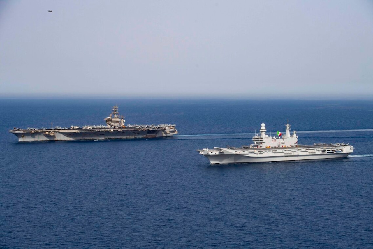 Two ships sail next to each other on the ocean.