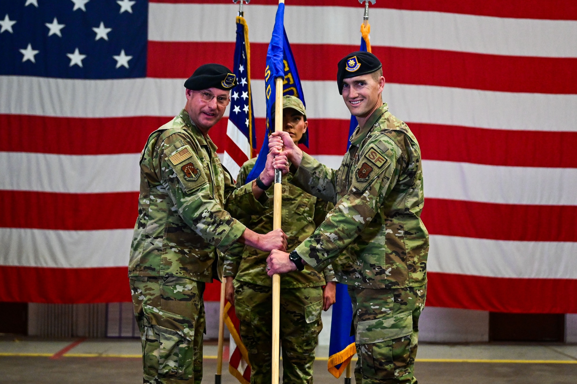 Col. Secrest passes the guidon to Maj. Shrinkle.