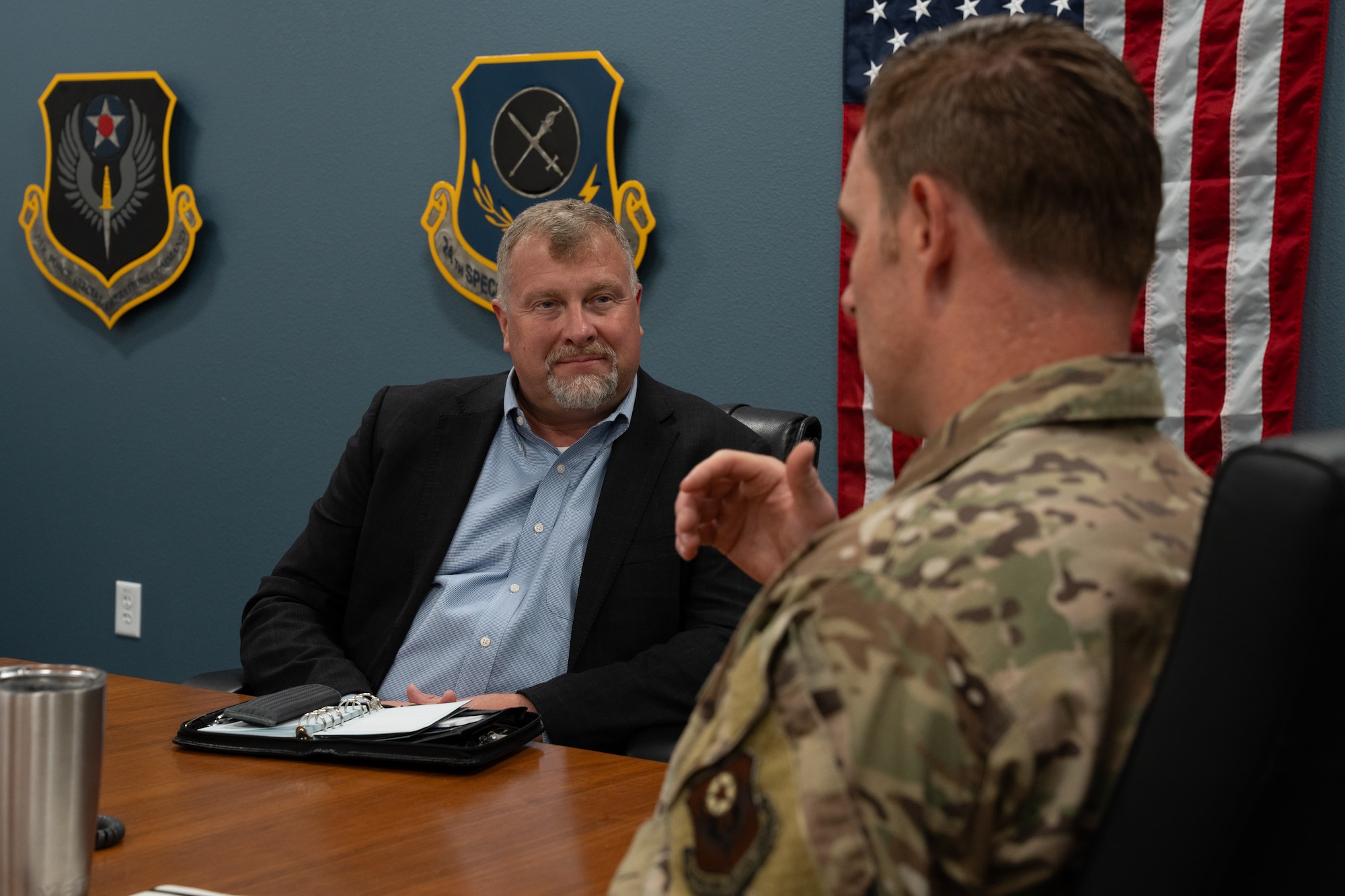 Mr. Dwayne DeCann, U.S. Special Operations Command NGA Support Team analysis director, sits in a meeting with U.S. Air Force members assigned to the 26th Special Tactics Squadron at Cannon Air Force Base, New Mexico, May 29, 2024. DeCann spent two days with the 27th Special Operations Wing to better understand both the mission of the Steadfast Line, as well as the geospatial intelligence requirements of the wing. (U.S. Air Force photo by Airman 1st Class Tori Shearn)