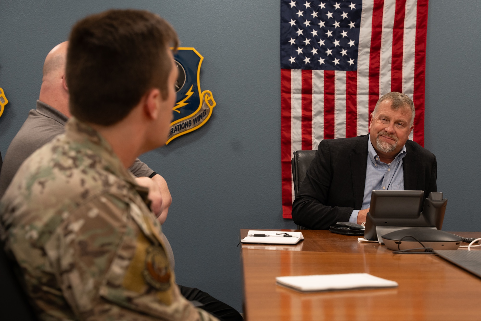 Mr. Dwayne DeCann, U.S. Special Operations Command NGA Support Team analysis director, sits in a meeting with U.S. Air Force members assigned to the 26th Special Tactics Squadron at Cannon Air Force Base, New Mexico, May 29, 2024. DeCann spent two days with the 27th Special Operations Wing to better understand both the mission of the Steadfast Line, as well as the geospatial intelligence requirements of the wing. (U.S. Air Force photo by Airman 1st Class Tori Shearn)