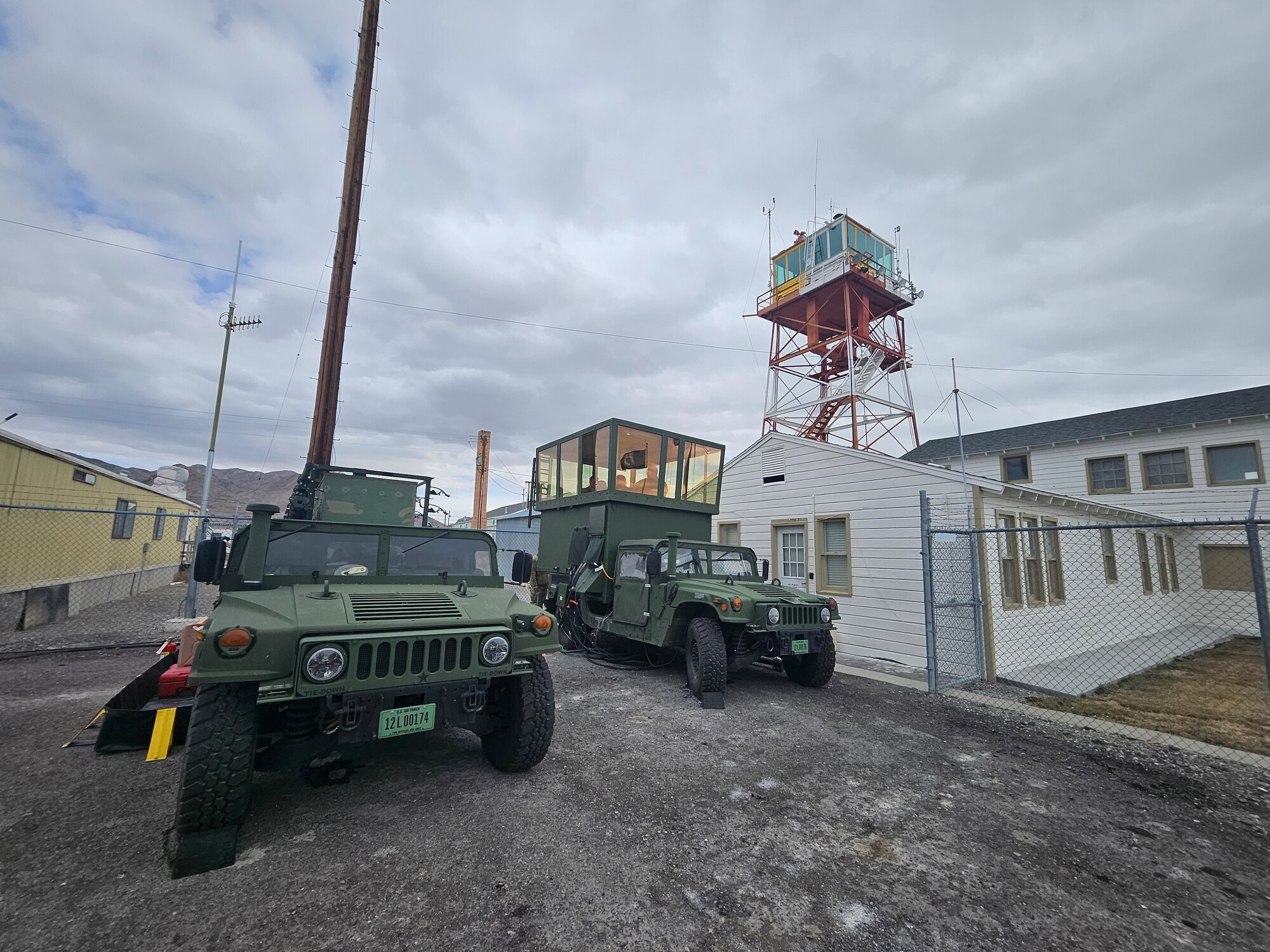 A mobile air traffic control tower sits below a World War II tower facility.