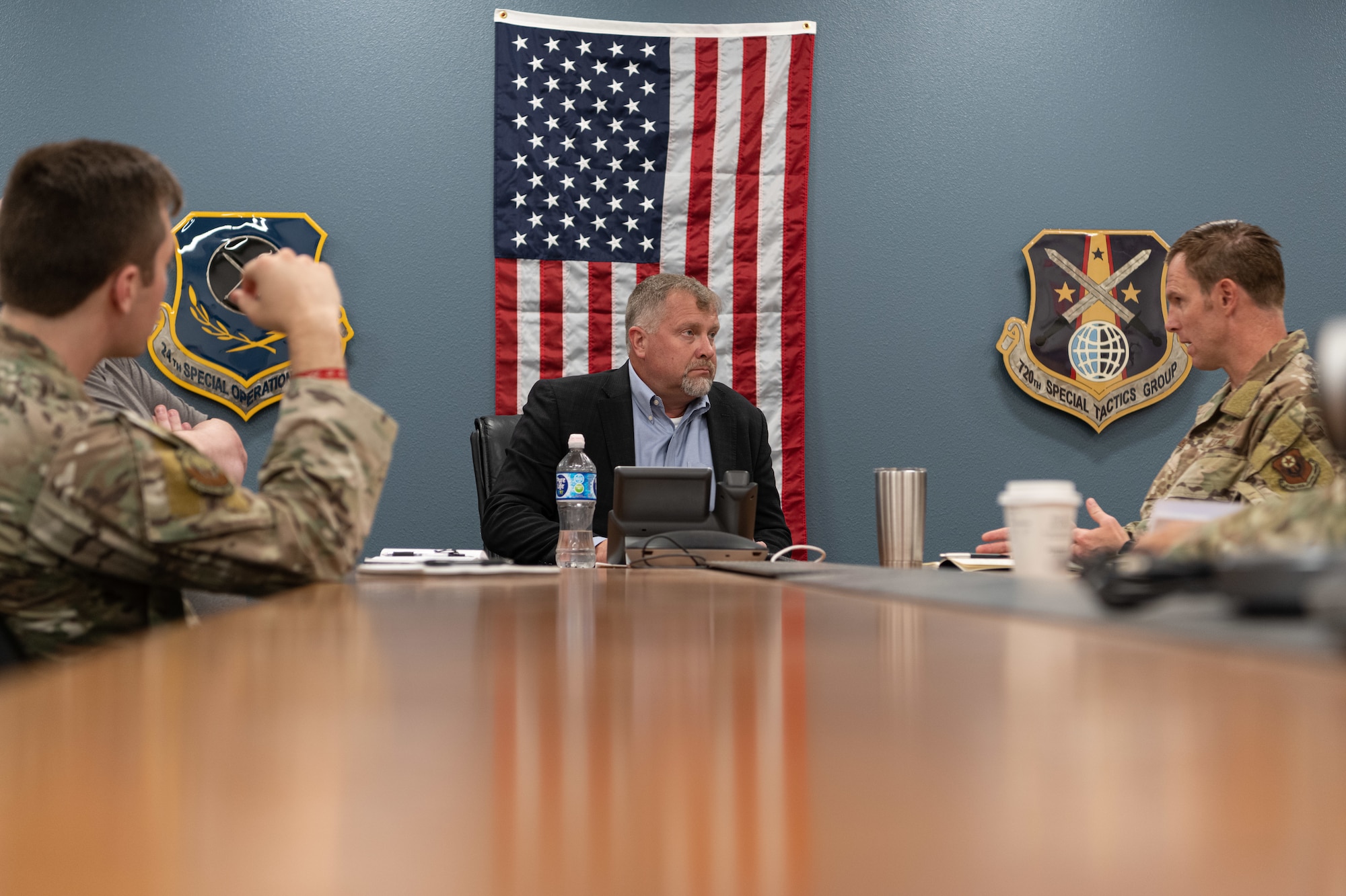 Mr. Dwayne DeCann, U.S. Special Operations Command NGA Support Team analysis director, sits in a meeting with U.S. Air Force members assigned to the 26th Special Tactics Squadron at Cannon Air Force Base, New Mexico, May 29, 2024. DeCann spent two days with the 27th Special Operations Wing to better understand both the mission of the Steadfast Line, as well as the geospatial intelligence requirements of the wing. (U.S. Air Force photo by Senior Airman Drew Cyburt)