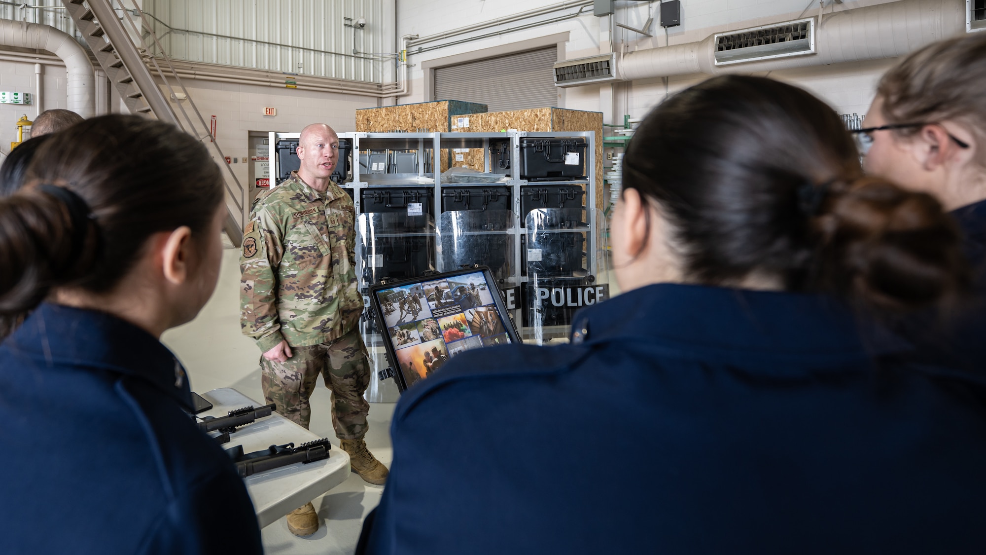 Master Sgt. Blake Nicholson, a security forces specialist assigned to the 123rd Airlift Wing, talks to students from the Casey County High School’s Air Force JROTC program about military policing during their tour of the Kentucky Air National Guard Base in Louisville, Ky., March 14, 2024. The base is home to about 1,200 Airmen and eight C-130J Super Hercules aircraft, with missions spanning the gamut from tactical airlift, special operations, disaster response, explosive ordnance disposal and aircraft maintenance to civil engineering, cyber communications, security forces, medical care and logistics. (U.S. Air National Guard photo by Dale Greer)