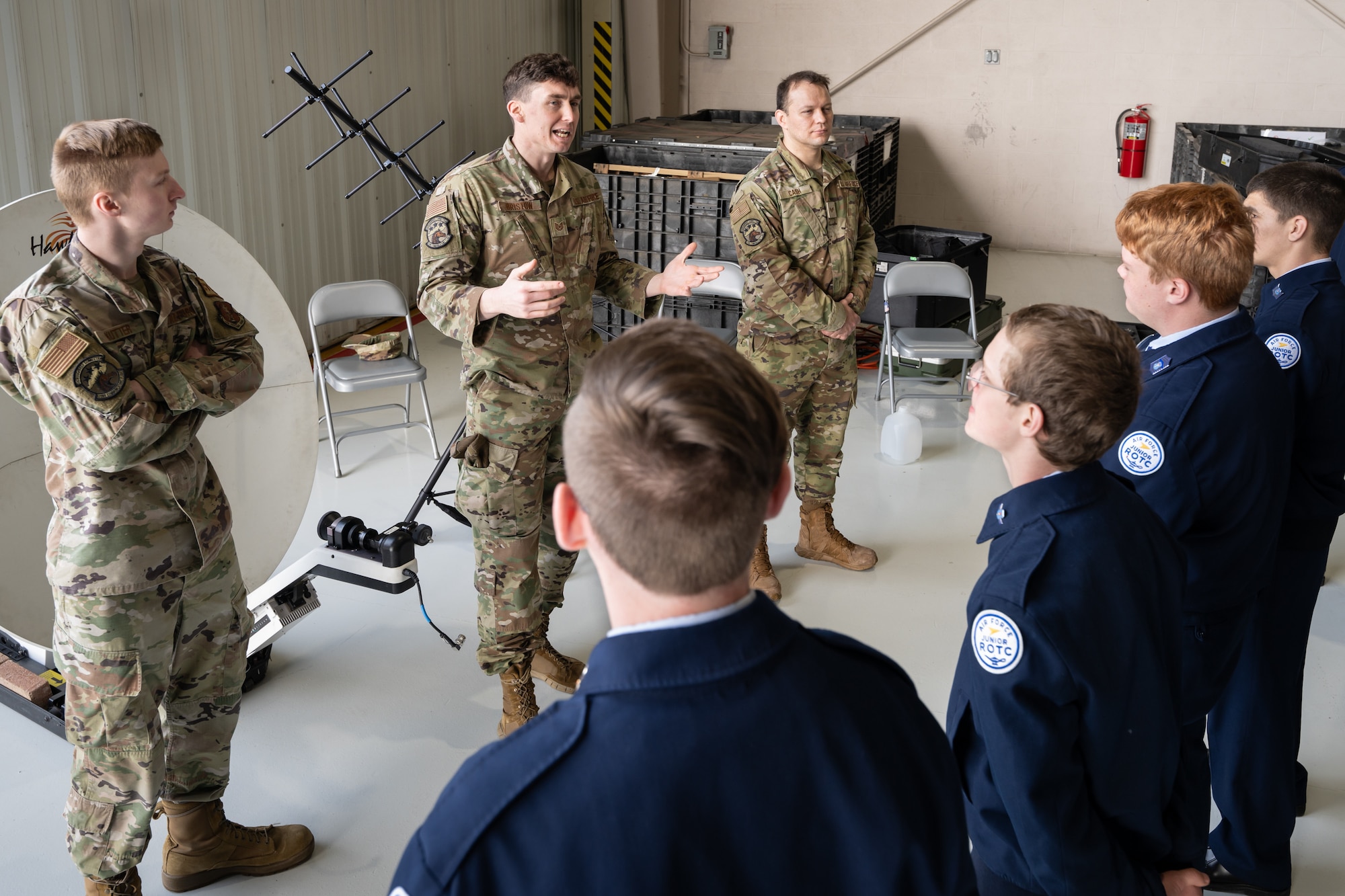 Tech. Sgt. Elliott Bristow, a cyber systems operator assigned to the 123rd Airlift Wing, talks to students from the Casey County High School’s Air Force JROTC program about cyber communications during their tour of the Kentucky Air National Guard Base in Louisville, Ky., March 14, 2024. The base is home to about 1,200 Airmen and eight C-130J Super Hercules aircraft, with missions spanning the gamut from tactical airlift, special operations, disaster response, explosive ordnance disposal and aircraft maintenance to civil engineering, cyber communications, security forces, medical care and logistics. (U.S. Air National Guard photo by Dale Greer)