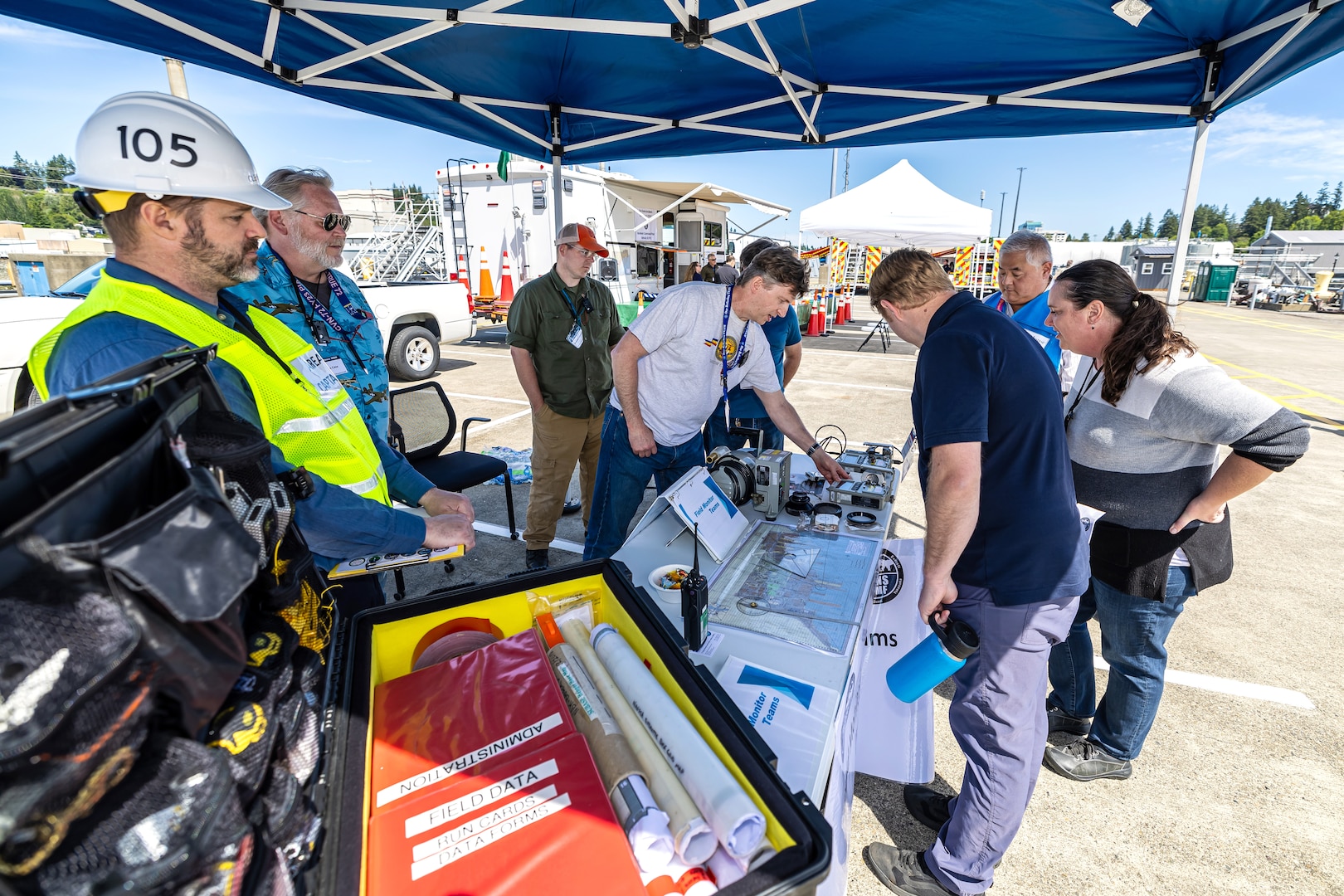 Washington Emergency Management Division employees, left, listen to a presentation on radiological emergency planning June 6, 2024, during a command visit for state, county and local emergency management partners on Naval Base Kitsap in Bremerton, Washington. (U.S Navy photos by Jeb Fach)