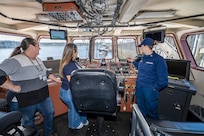 Petty Officer First Class Keisha Kerr leads a tour of USCGC Sea Lion (WPB-87352) June 6, 2024, for Washington Emergency Management Division employees Sarah Foster and Casey Broom at Puget Sound Naval Shipyard & Intermediate Maintenance Facility in Bremerton, Washington. (U.S. Navy photo by Jeb Fach)