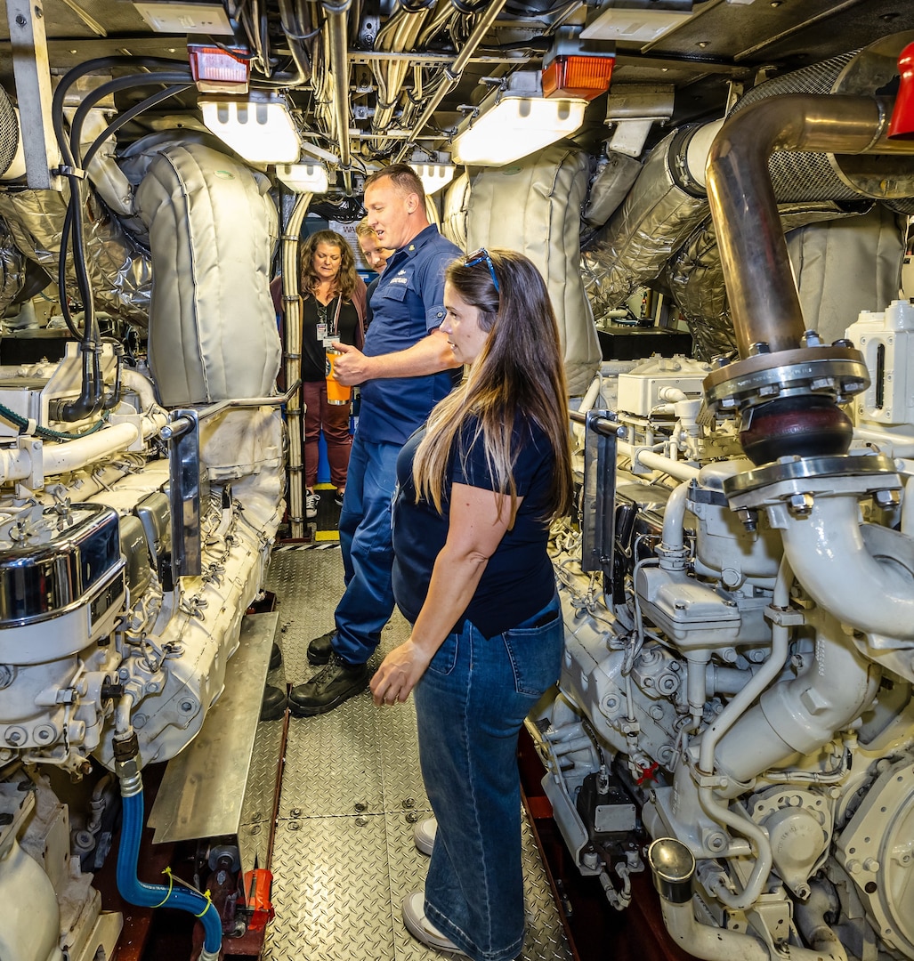 Machinery Technician Chief Petty Officer Jefferey Sheets leads a tour of the engine room aboard USCGC Sea Lion (WPB 87352) June 06, during a command visit for emergency management partner agencies on Naval Base Kitsap. (U.S. Navy photos by Jeb Fach)