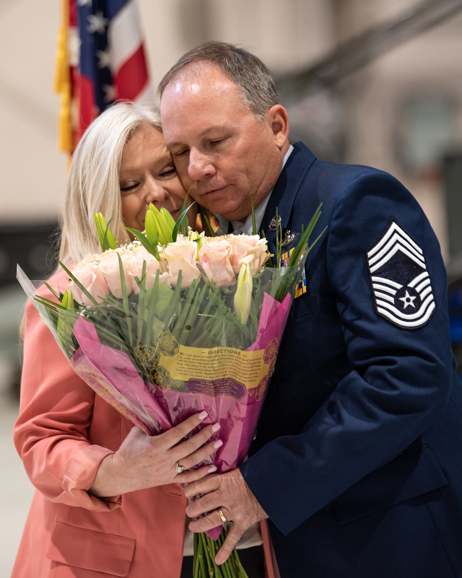 Chief Master Sgt. Alan Peake, right, presents a bouquet of flowers to his wife during his retirement ceremony at the Kentucky Air National Guard Base in Louisville, Ky., Apr. 21, 2024. Peake retired as the maintenance production superintendent for the 123rd Aircraft Maintenance Squadron after more than 36 years of service. (U.S. Air National Guard photo by Staff Sgt. Chloe Ochs)